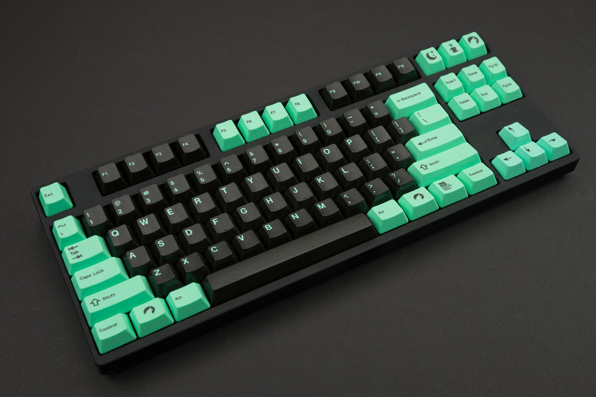 DCS Midnight keycap set with dark alphas and glow-in-the-dark mint modifiers on a TKL keyboard
