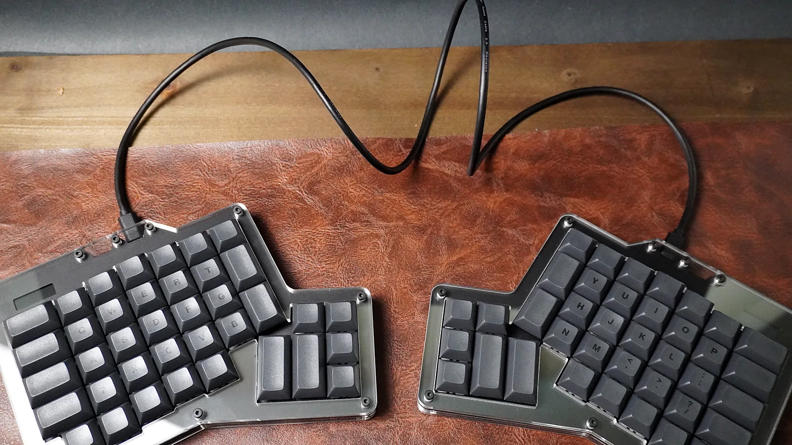 ErgoDox 76 Hot Dox V2 halves spaced apart with a USB-C cable linking them