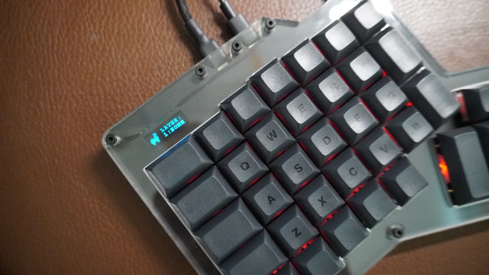 ErgoDox 76 Hot Dox V2 left half with the screen showing the active layer, 1:HOME, and red RGB backlighting