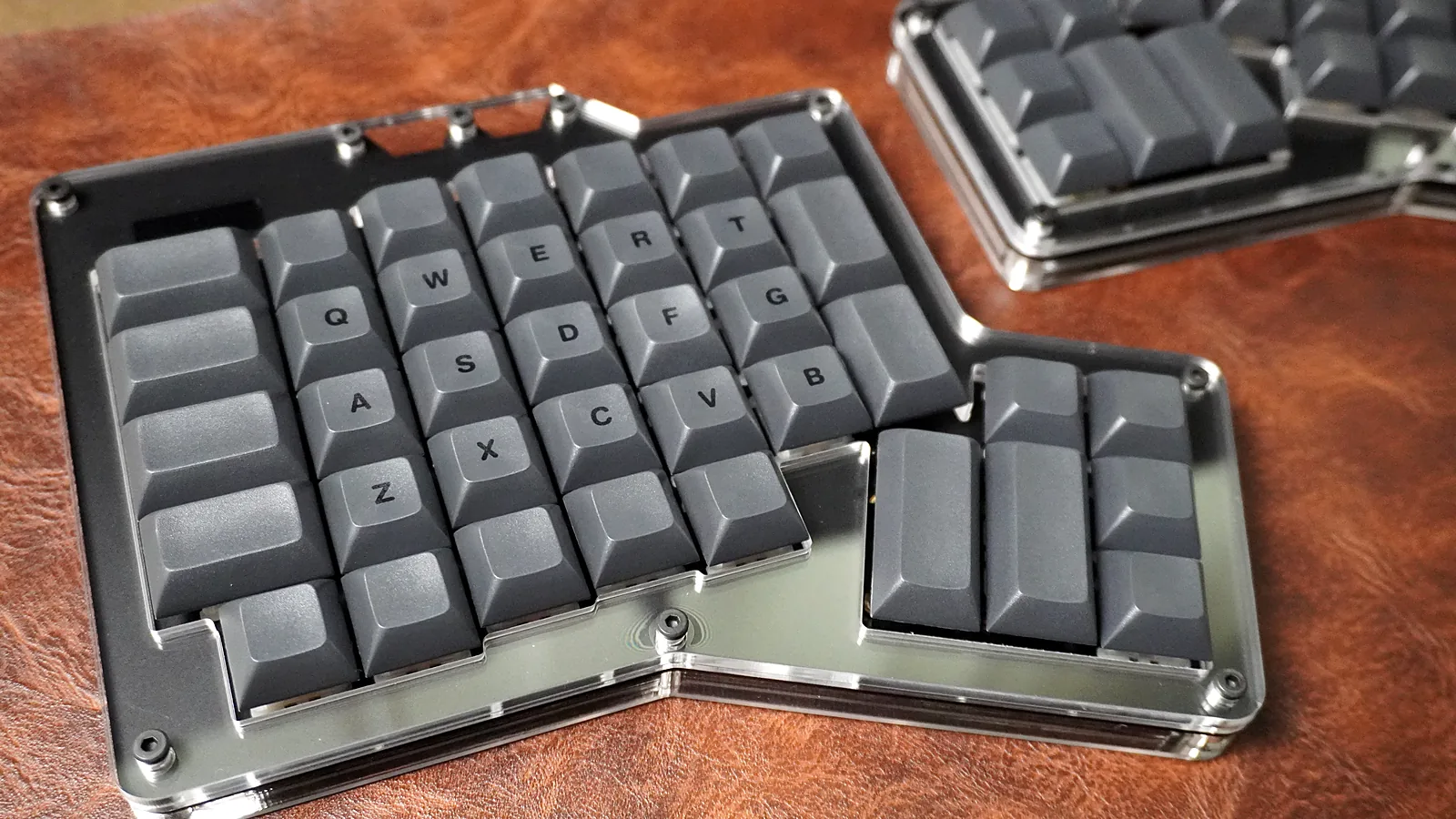 Close-up of the ErgoDox 76 Hot Dox V2 left half with QWERTY legends and the thumb cluster